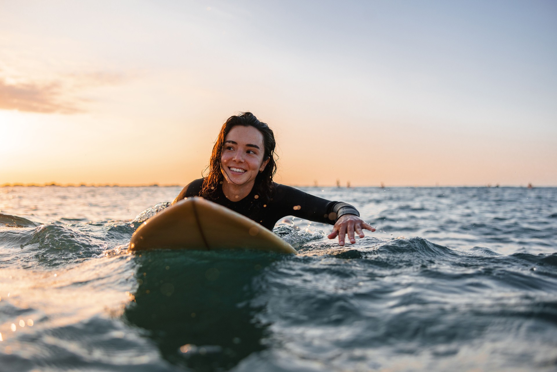 Professional Female Surfer Practicing Her Surfing During A Solo Surfing Session At Sunrise