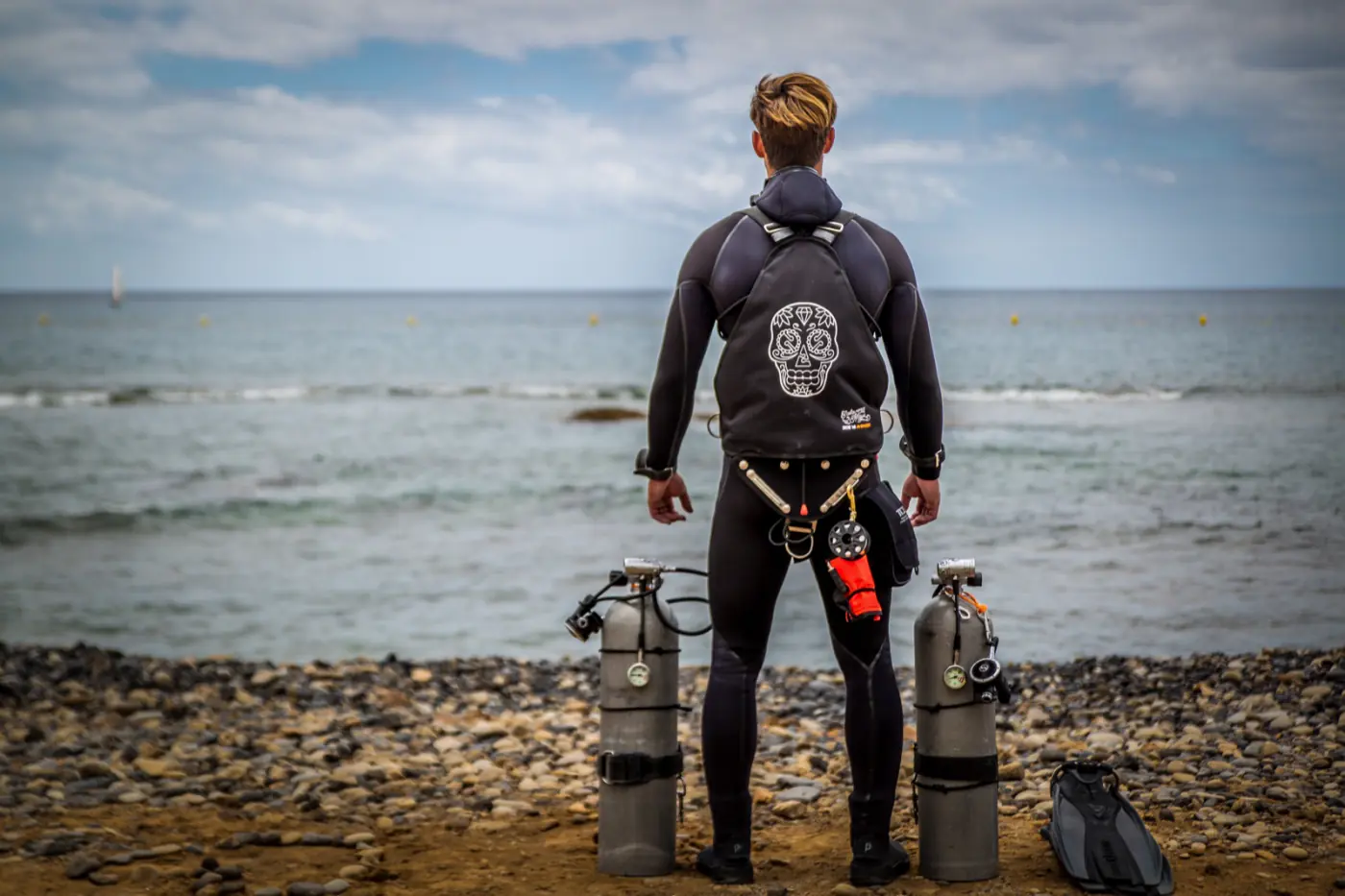 A diver in full gear by the sea in Los Cristianos, Tenerife