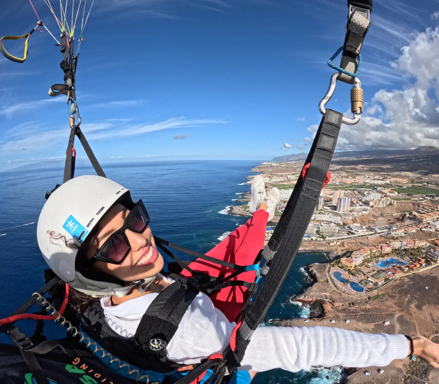 A passenger smiling during a paragliding flight in Tenerife